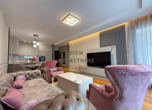 Modern and bright living room with a dining area and kitchen in the background.