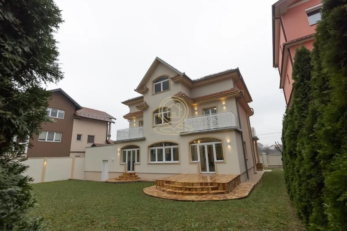 Exterior view of the house with a yard and terraces.