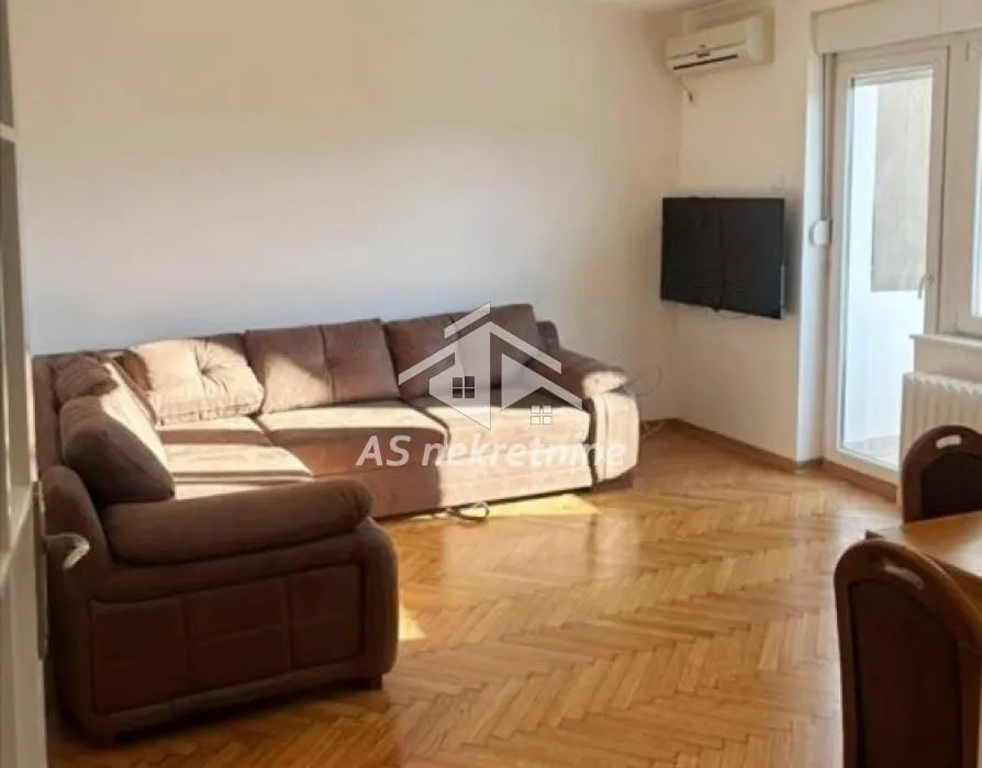Living room with a sofa set and parquet flooring.