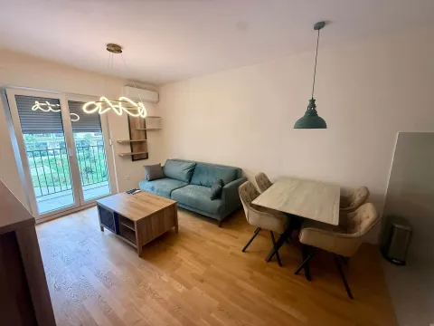 Living room with a sofa and dining table. - image 2