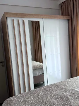 Bedroom featuring a large sliding-door wardrobe with a mirror. - image 14