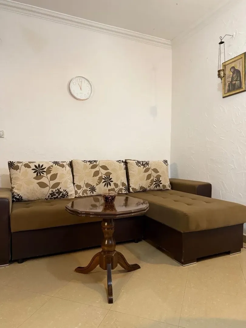 Living room with a sectional sofa and a small table.