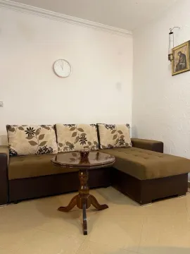 Living room with a sectional sofa and a small table. - image 4
