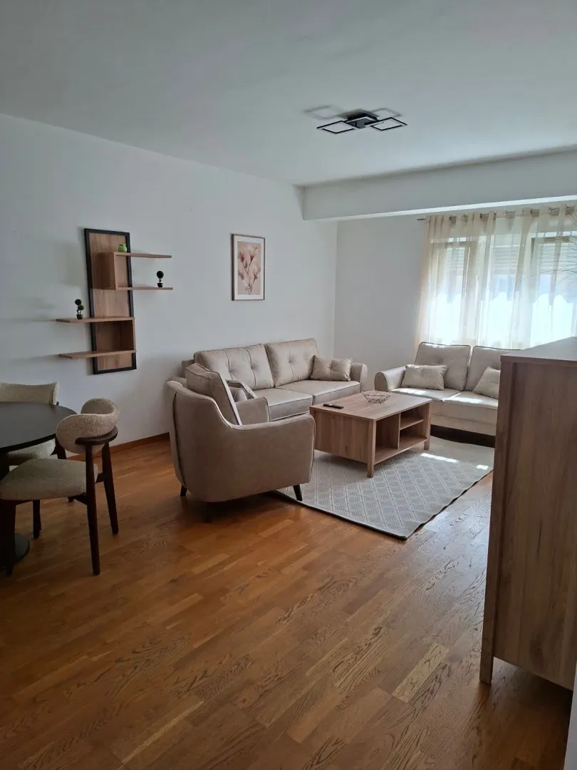Living room with a sofa set, coffee table, and dining table.