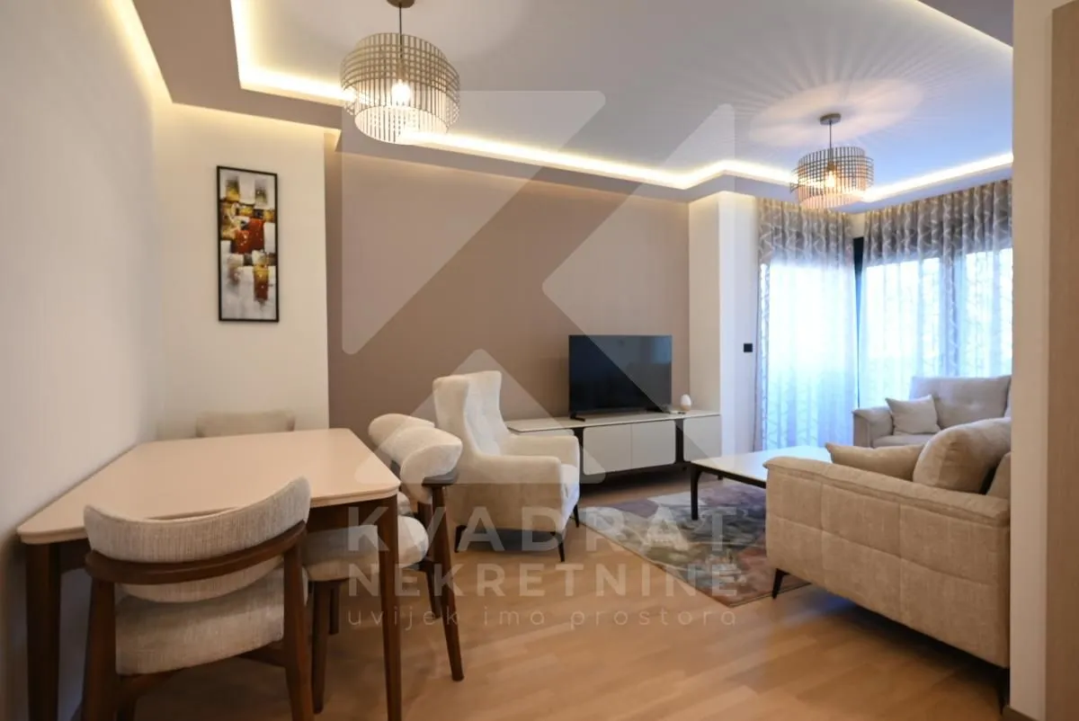 Spacious living room with a dining area and modern lighting.