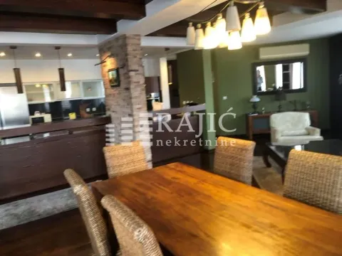 Living room with dining area and open-plan kitchen space. - image 14