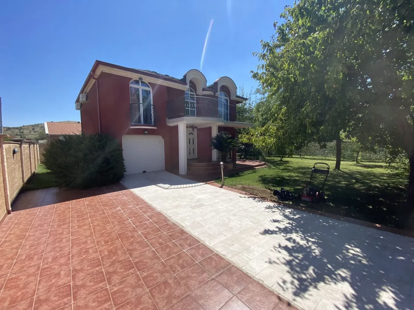 Two-story house with a yard and garage.