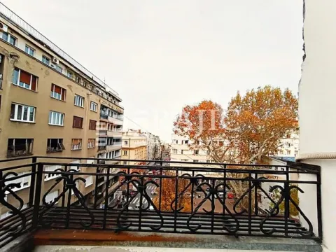 View from the balcony overlooking the city street and surrounding buildings. - image 8