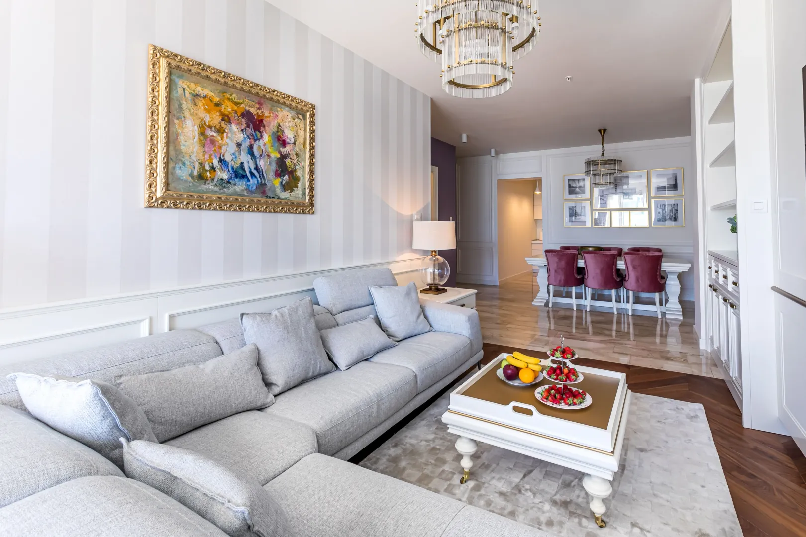 Modern and bright living room with a sofa set and dining area in the background.