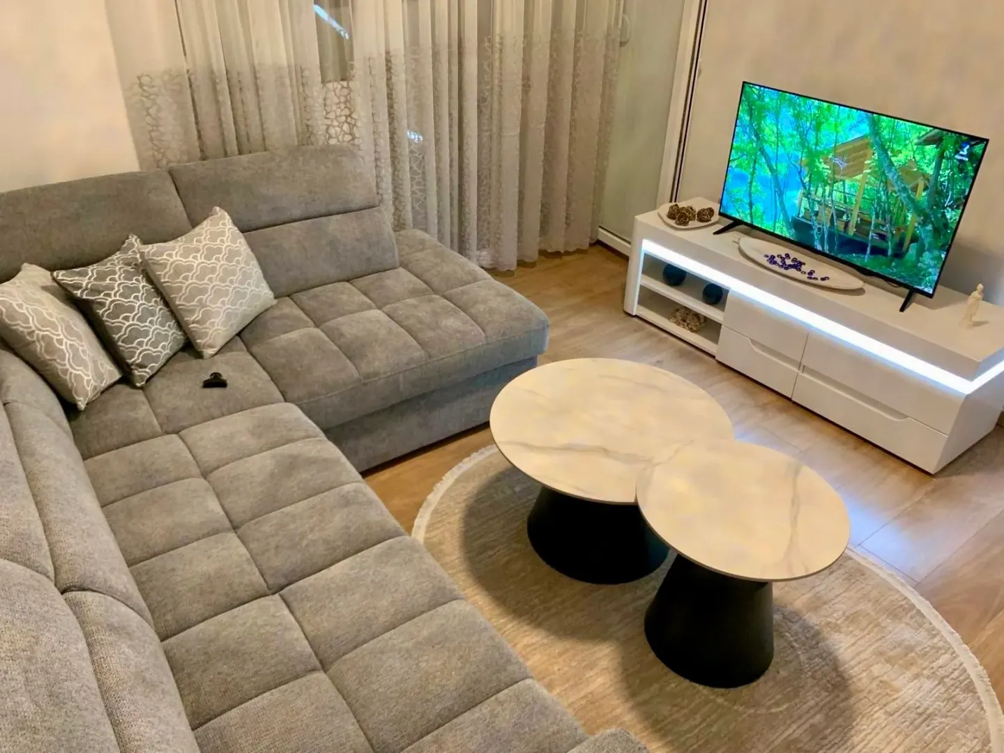 Comfortable living room with a sectional sofa, coffee table, and TV.