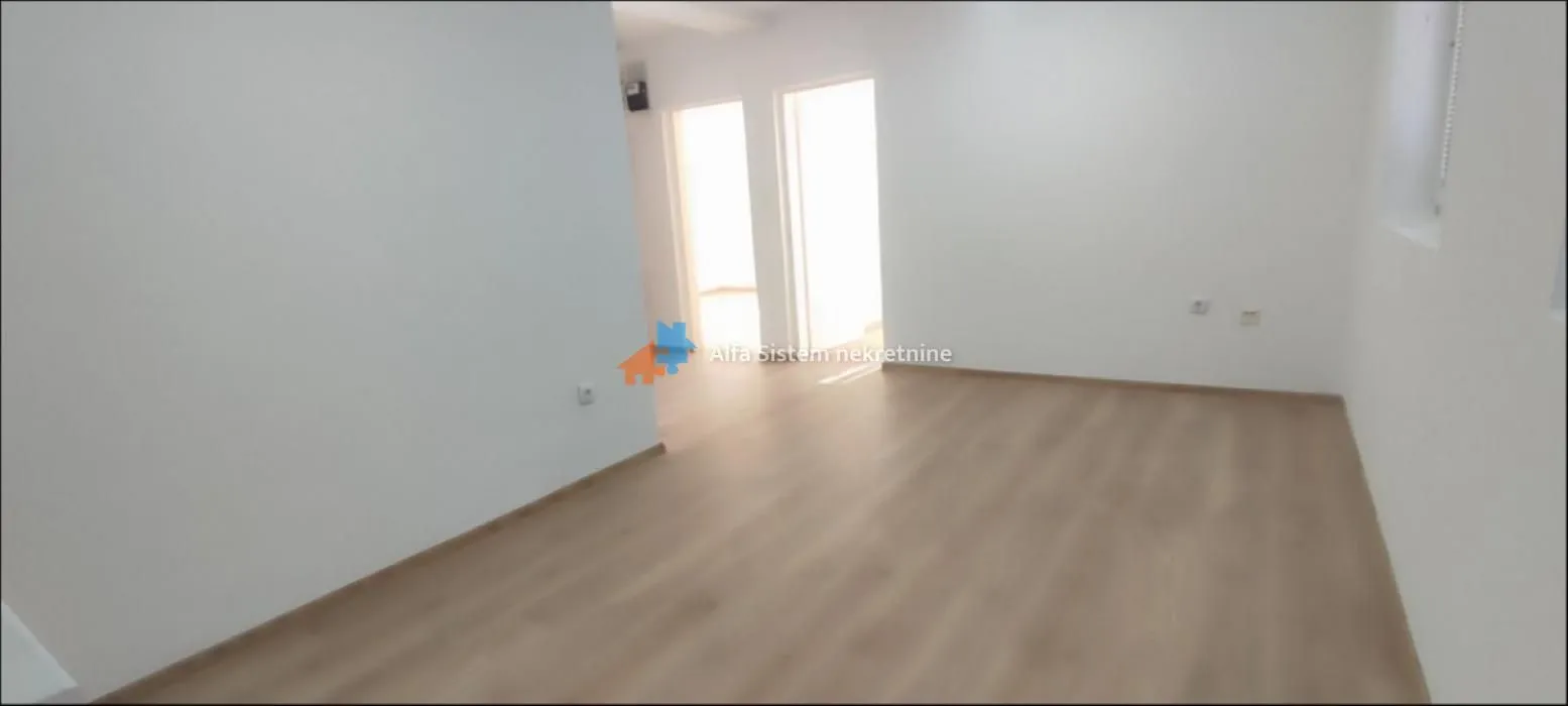 Empty unfurnished room with laminate flooring and white walls.
