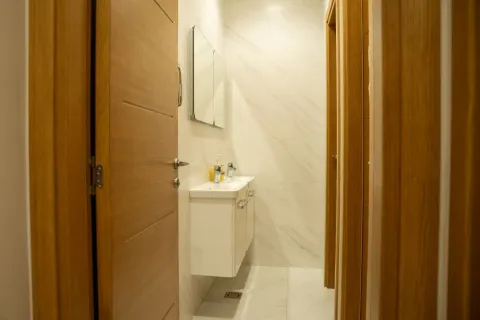 View of a modern bathroom with a sink and a mirror. - image 13