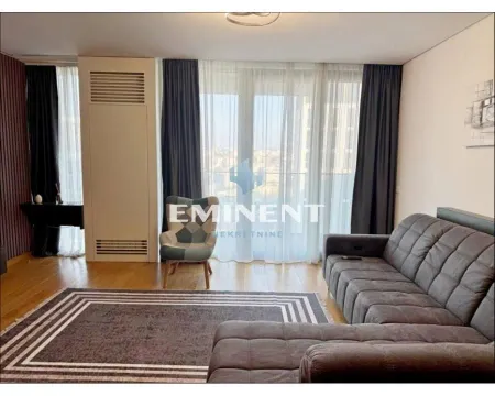 Living room with a sectional sofa, armchair, and a large window with curtains. - image 16