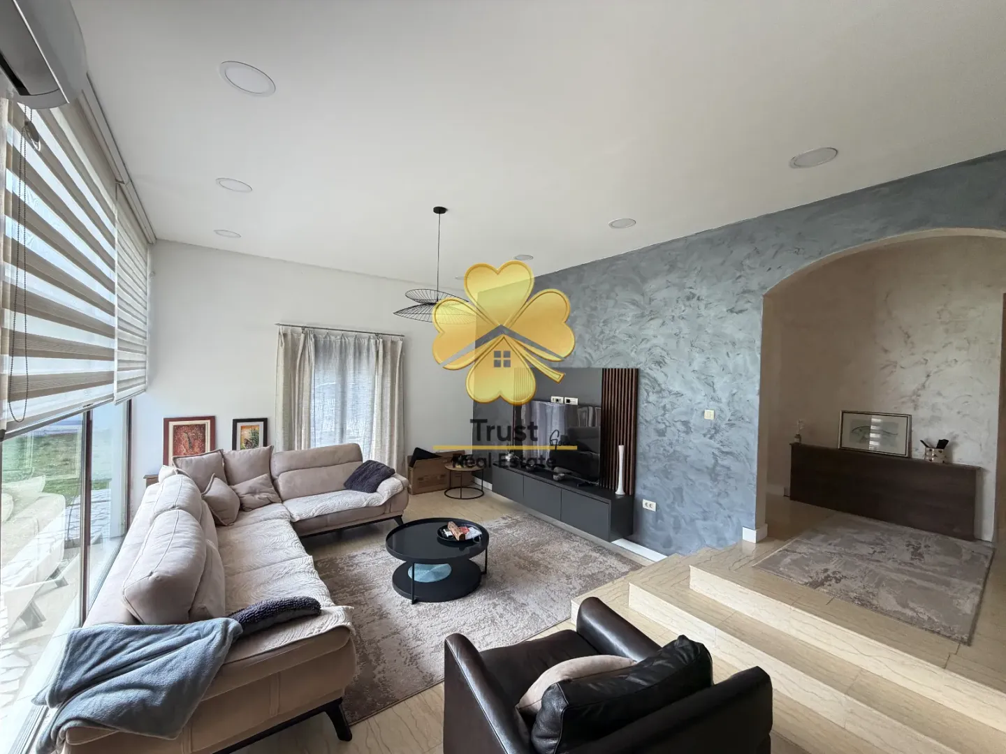Modern living room with a sofa and TV unit.