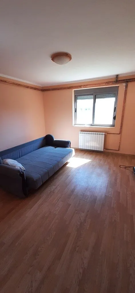 Living room with a sofa and a window.