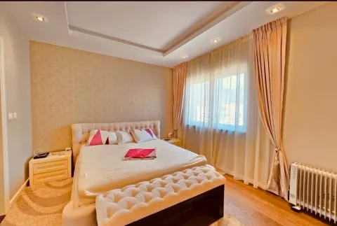 Furnished bedroom with a double bed and a large window. - image 3