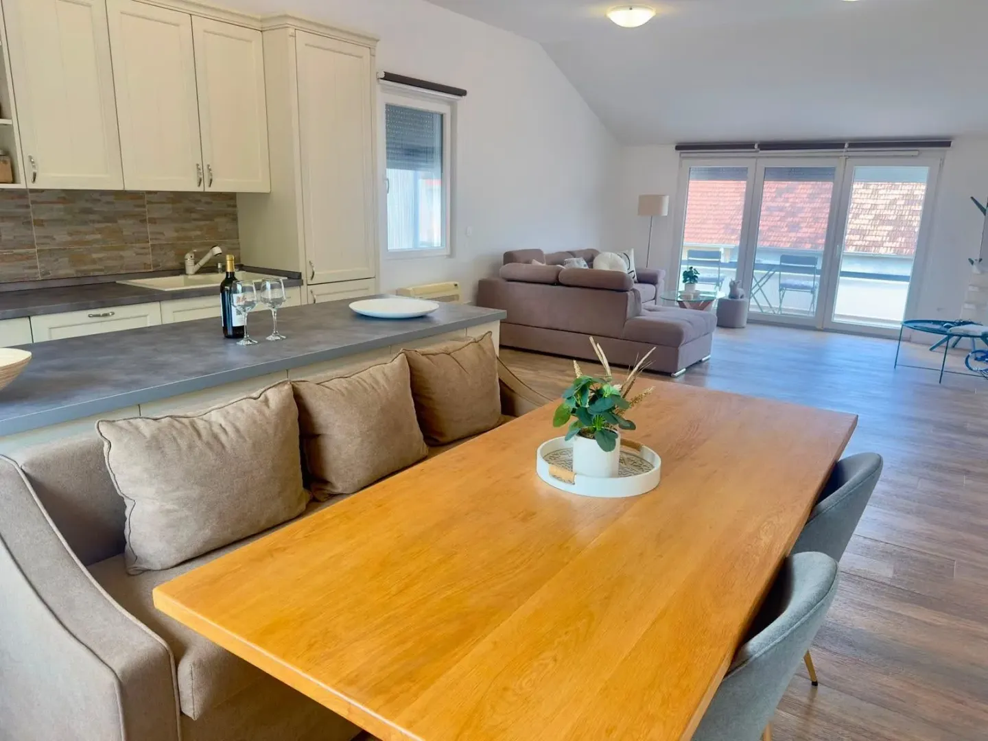 Spacious bright living room with dining area and kitchen.