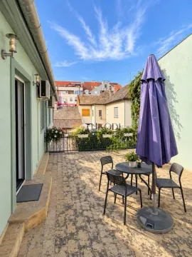 Spacious terrace with seating furniture and a parasol. - image 11