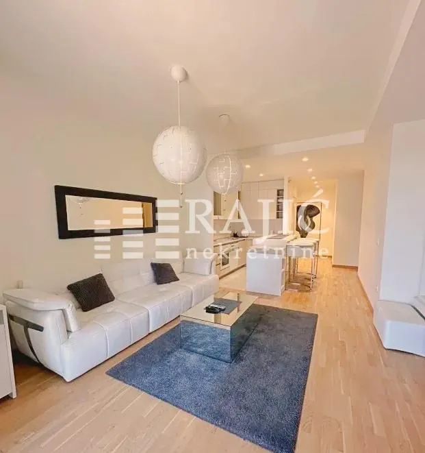 Modern living room connected to the dining area and kitchen.