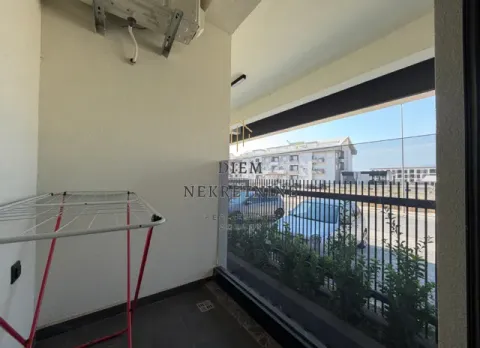 Small balcony with a clothes drying rack and street view. - image 9