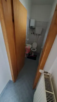 Pogled na kupatilo sa toaletom kroz otvorena vrata. - image 12