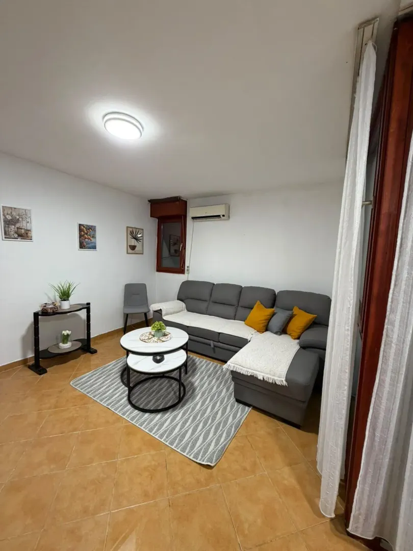 Living room with a sectional sofa, coffee table, and decor.