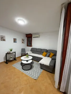 Living room with a sectional sofa, coffee table, and decor. - image 2