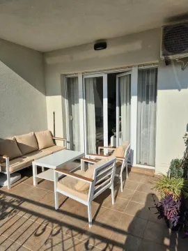 Furnished covered terrace with seating set and access to the apartment. - image 20