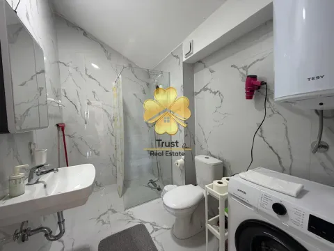 Modern equipped bathroom with a shower cabin and washing machine. - image 9