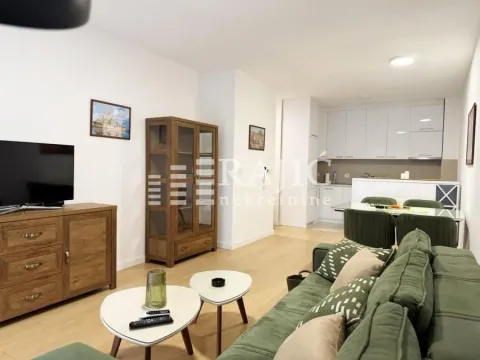Living room with dining area and kitchen in light tones. - image 2
