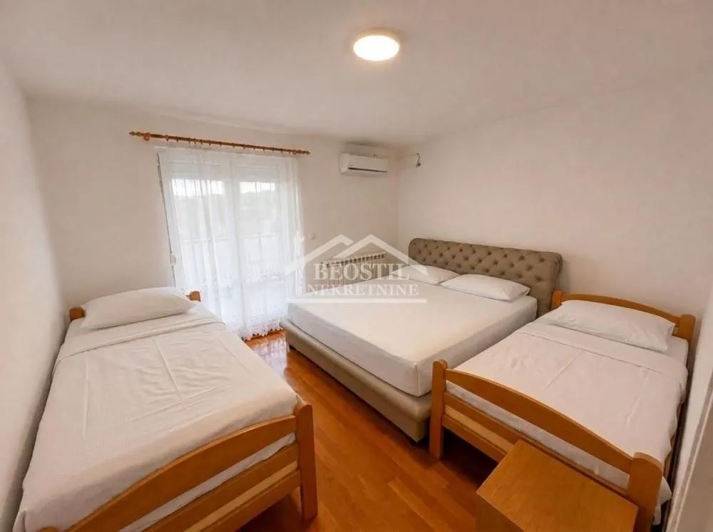 Bedroom with one double bed and two single beds.