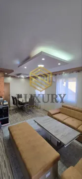 Spacious living room with a sofa set and dining area. - image 17