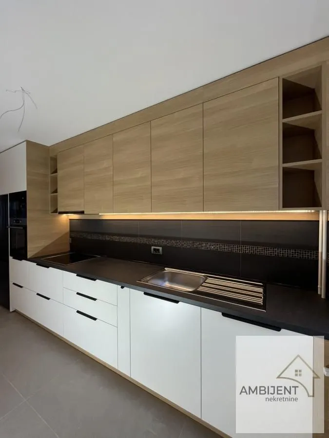 Modern kitchen with wooden cabinetry and a built-in sink.