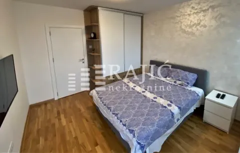 Furnished bedroom with a double bed, wardrobe, and chest of drawers. - image 5