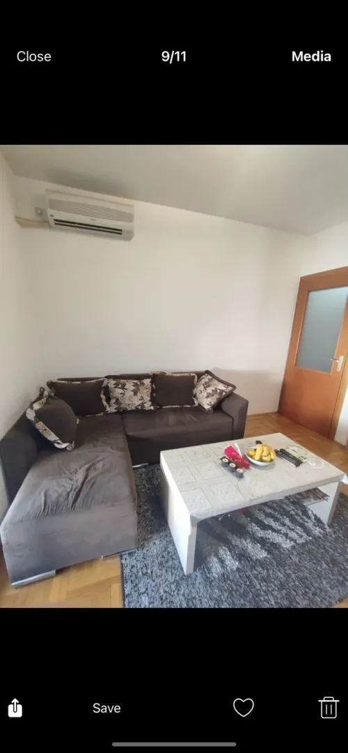 A living room featuring a brown sectional sofa and a coffee table.