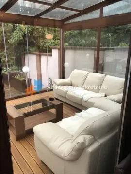 Enclosed glass terrace with seating furniture and wooden flooring. - image 27
