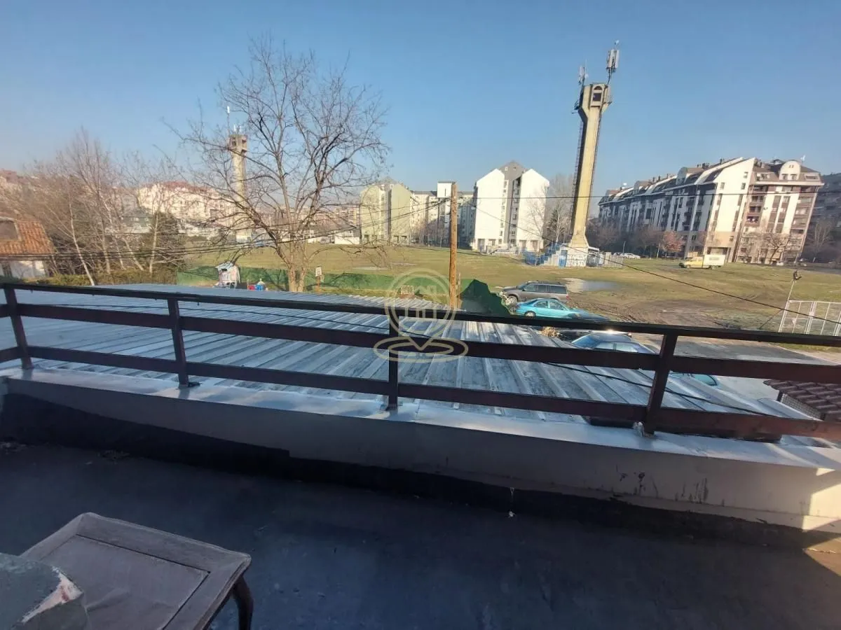 View from the terrace towards surrounding buildings and cityscape.
