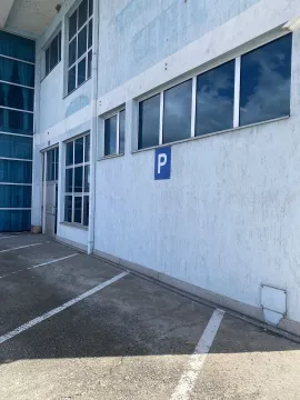 Exterior of a building and parking spaces. - image 10