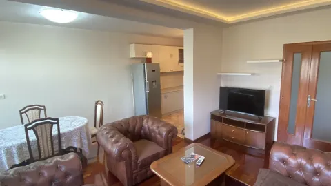 Living room with leather furniture, a dining table, and a view of the kitchen. - image 3