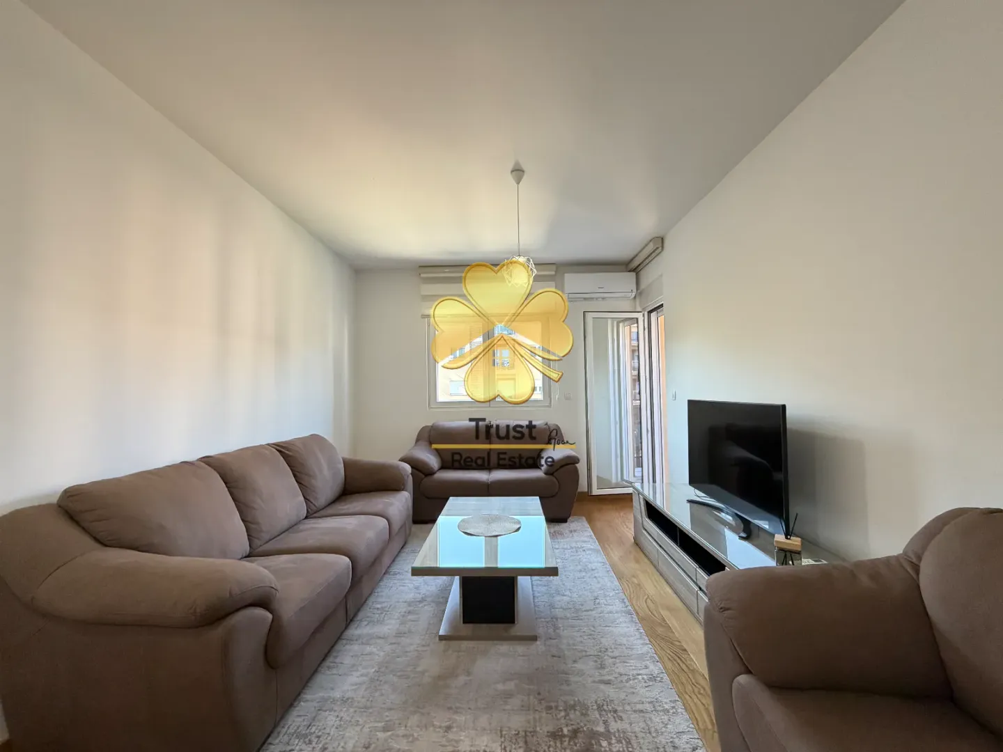 Living room with sofa, coffee table and television.