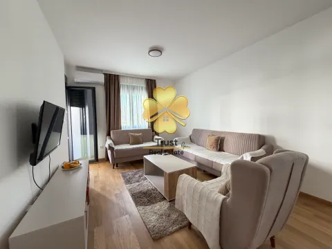 Living room with sofa set, coffee table, and TV. - image 3