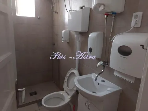 Smaller bathroom with a shower enclosure, toilet, and washbasin. - image 13