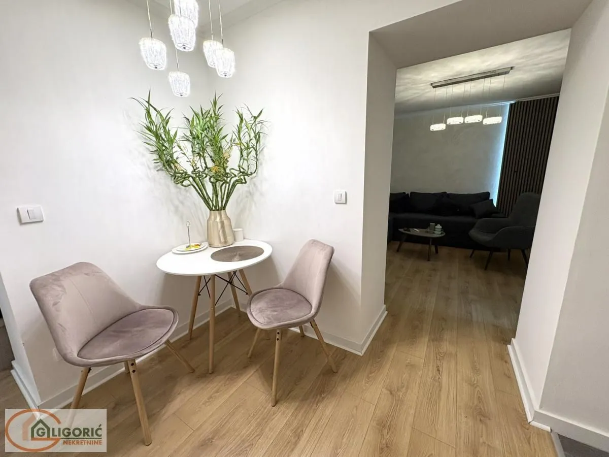 Dining nook with a table and two chairs overlooking the living room.