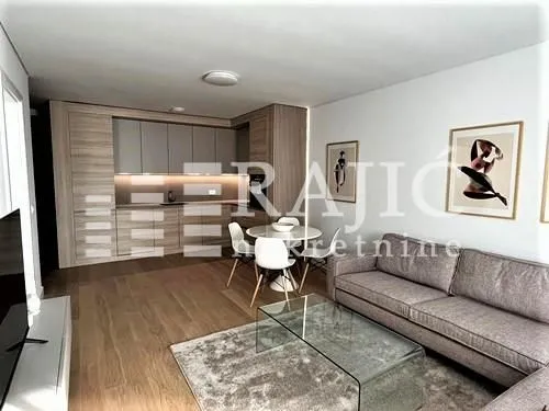 Modern living room with dining area and kitchen in the background.