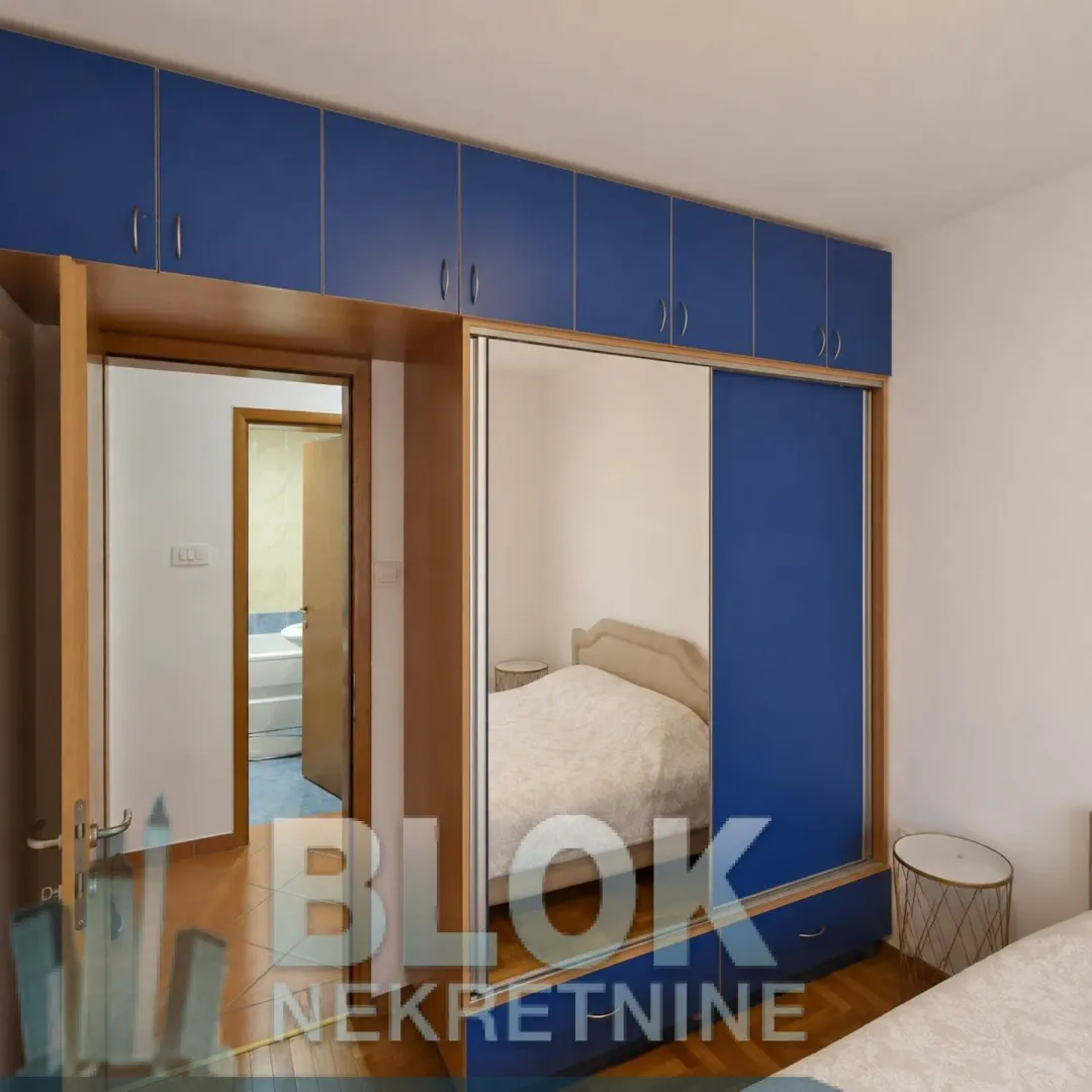 Bedroom with a large blue wardrobe and a bed.