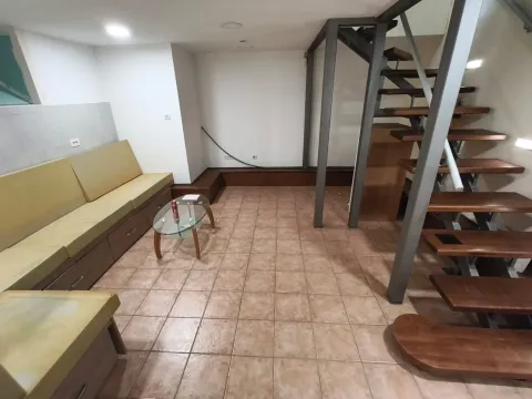 Living room with a sofa seating set and interior stairs. - image 4