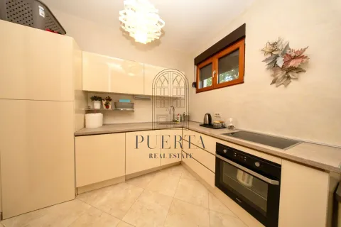 Small bright kitchen with beige cabinets and built-in appliances. - image 16