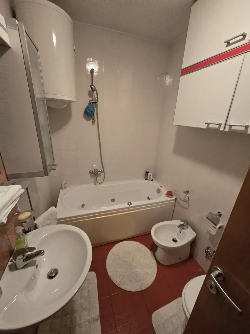 A simple bathroom featuring a bathtub and bidet.