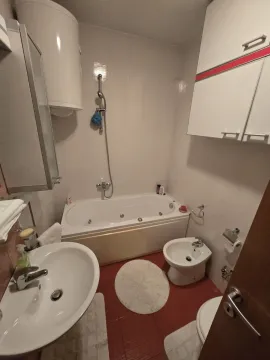 A simple bathroom featuring a bathtub and bidet. - image 15
