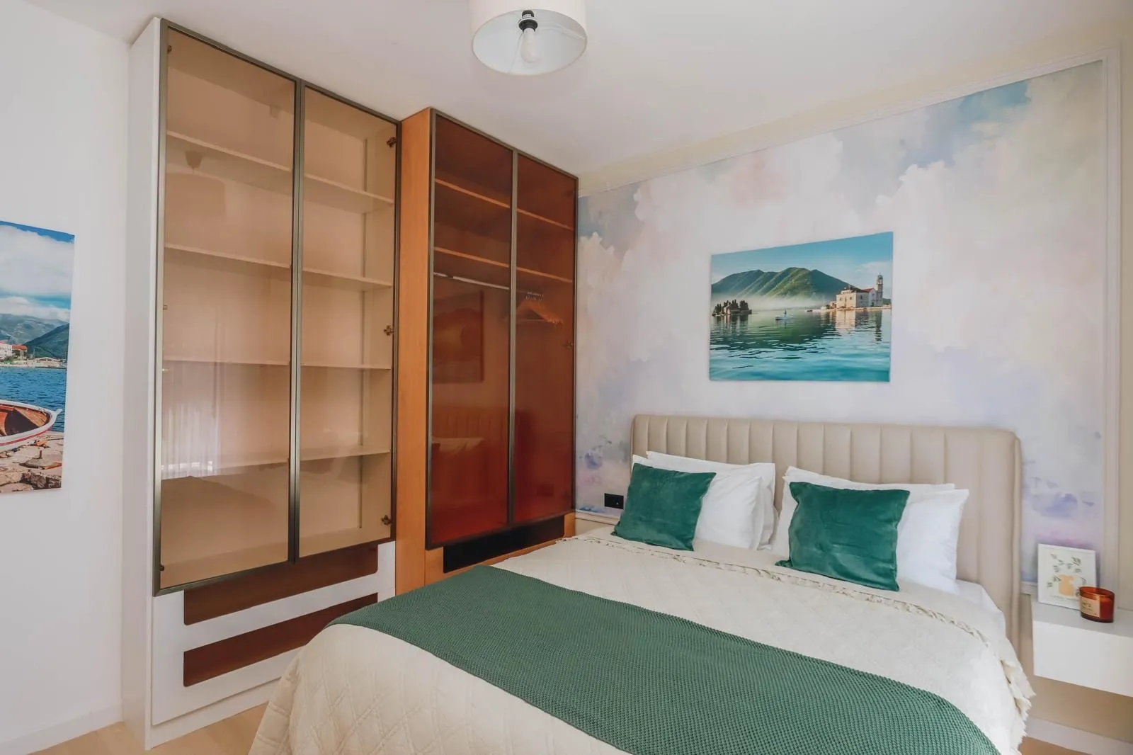 A furnished bedroom with a double bed and a large wardrobe.